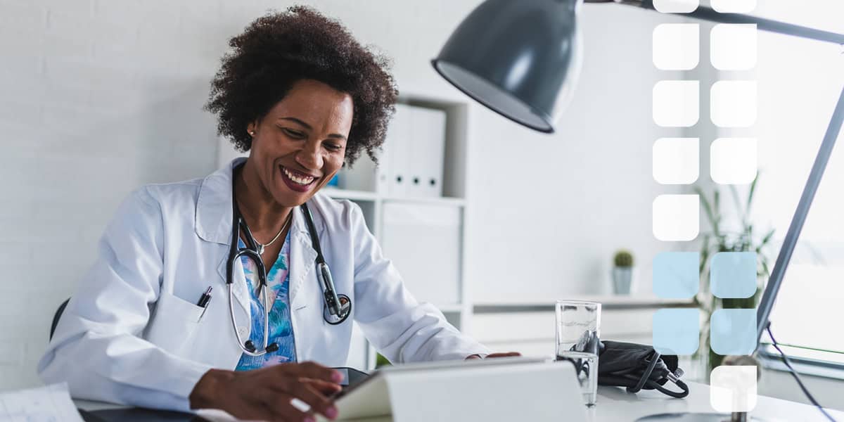 Doctor Smiling at Her Desk